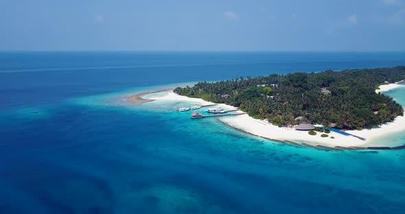 Daytime overhead abstract view of a white sand paradise beach and blue water background in 4K