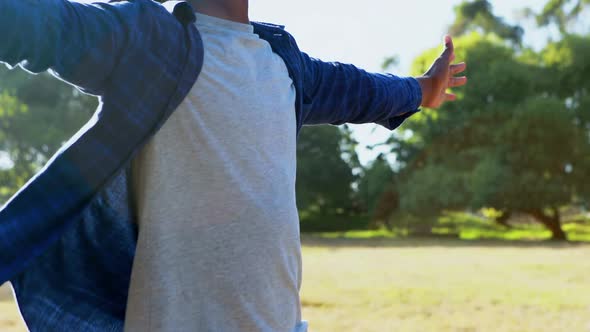 Man standing with arms wide open at festival 4k