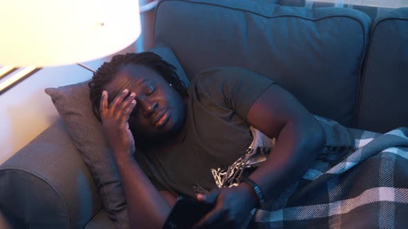 Sick African American Man Turning on the Couch