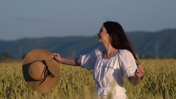 Young Girl Walking in Slow Motion Through a Wheat Field