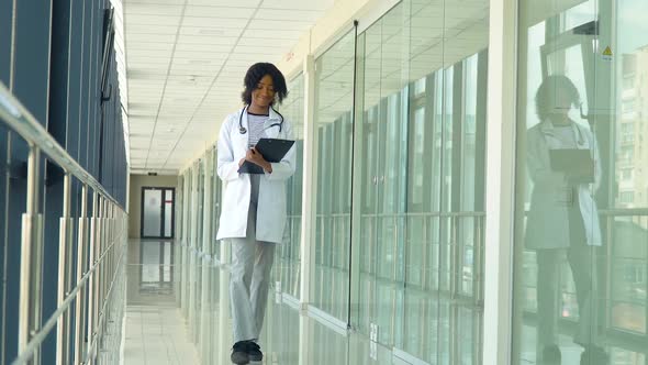 African American Doctor Walking in the Hospital. New Modern Fully Functional Medical Facility