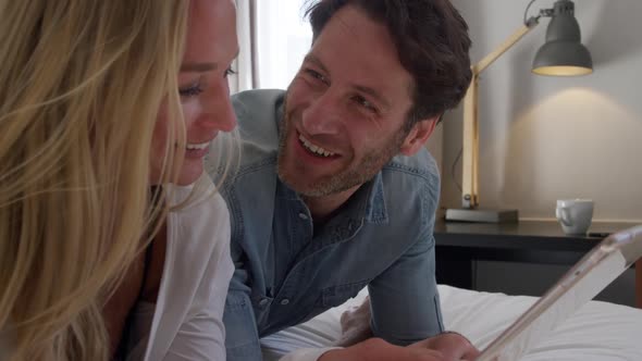 Young couple looking at a touch pad together