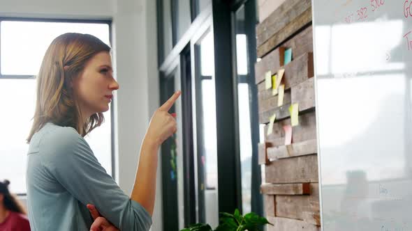 Business executive looking at sticky notes