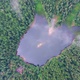 Aerial drone flight over mountain lake in pine forest in clouds - VideoHive Item for Sale