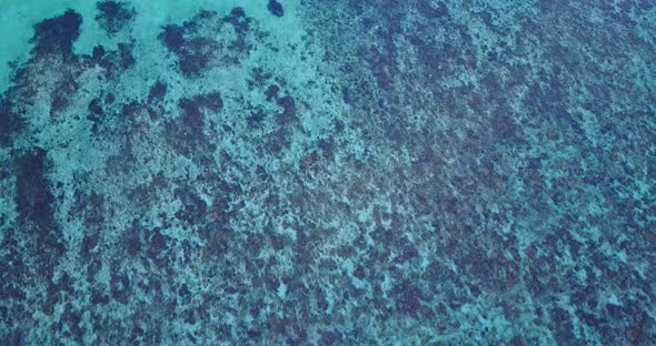 Wide flying tourism shot of a sunshine white sandy paradise beach and blue ocean background in best 