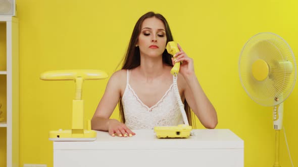 Young Woman Uses Old and New Telephones