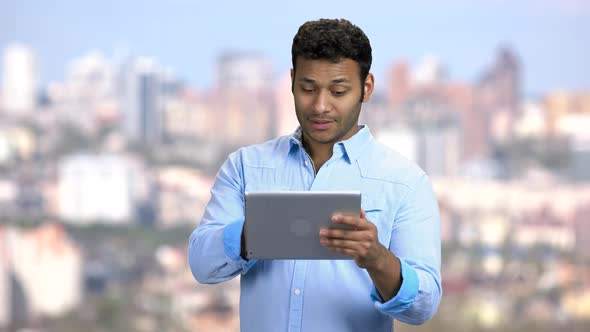 Handsome Man Waving with Hand Holding Tablet Pc