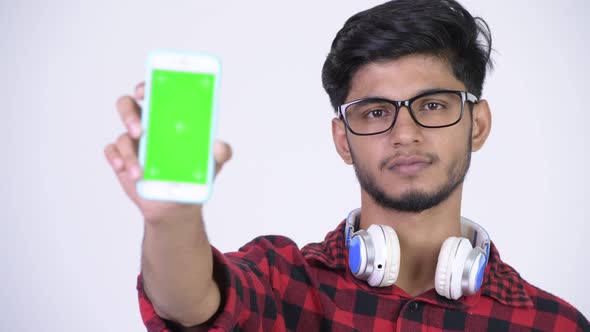 Young Happy Bearded Indian Hipster Man Showing Phone