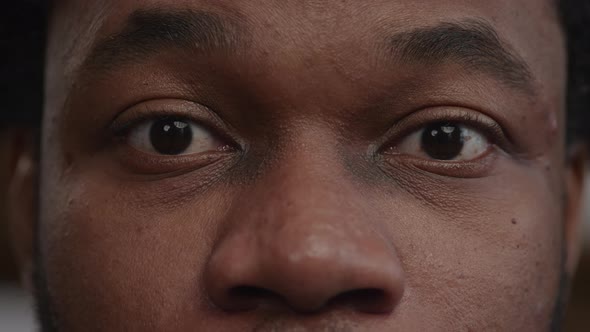 Extreme Closeup of a Surprised Africanamerican Man's Eyes Recieving Good News