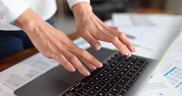 Female Hands are Typing on Laptop Keyboard