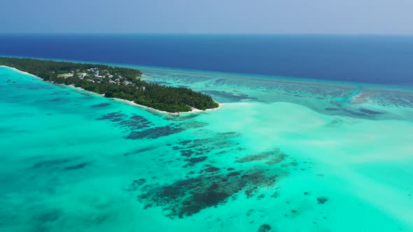 Aerial drone shot seascape of luxury island beach voyage by clear lagoon with white sandy background
