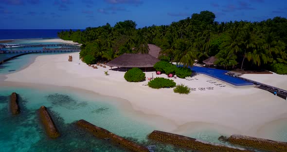 Beautiful above travel shot of a white paradise beach and aqua blue ocean background in high resolut