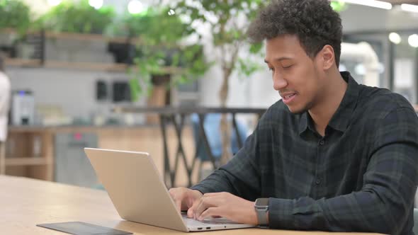 African American Man with Laptop Having Wrist Pain