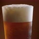 Pouring cool beer into a rotating glass. - VideoHive Item for Sale