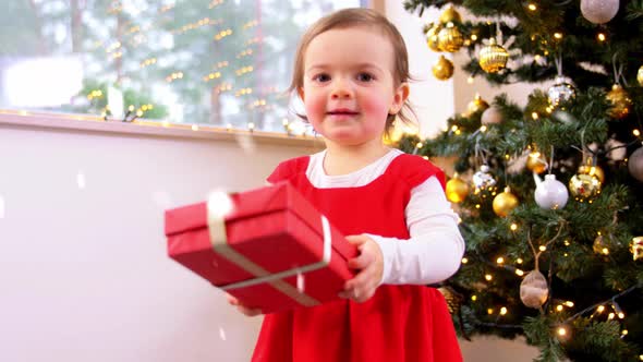 Happy Baby Girl with Christmas Gifts at Home