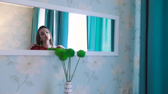 Beautiful woman dressing up near mirror at home. 