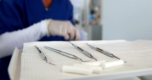 Smiling Dentist Preparing Dental Tools