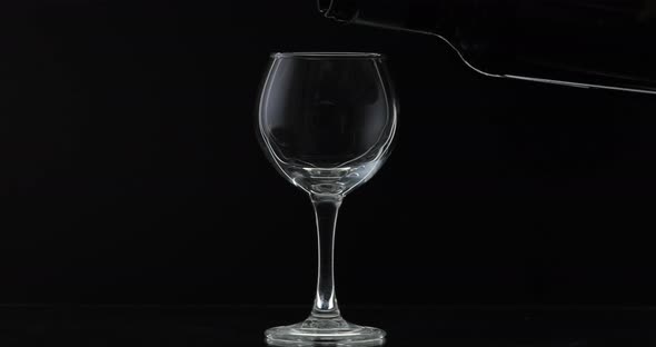 Rose Wine. Red Wine Pour in Wine Glass Over Black Background