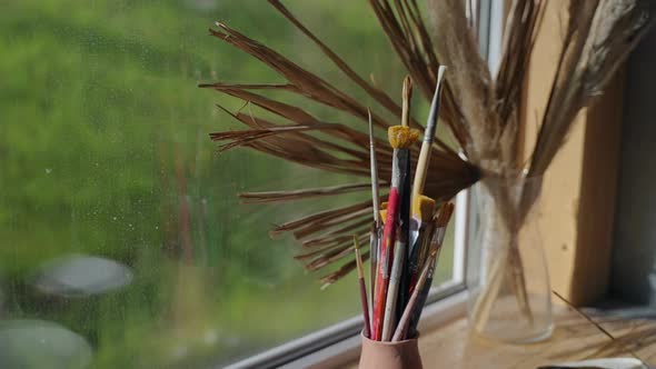 Inside Artistic Workshop Brushes on Windowsill