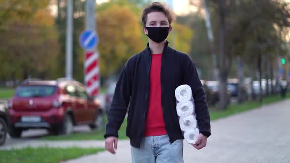Teen Walking in Medical Mask with Toilet Paper During the Second Wave Quarantine Coronavirus COVID