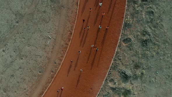 Aerial of children running on a clay circuit.