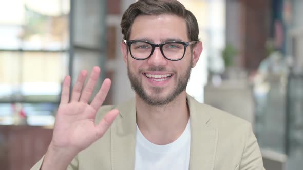 Young Man Waving Welcoming