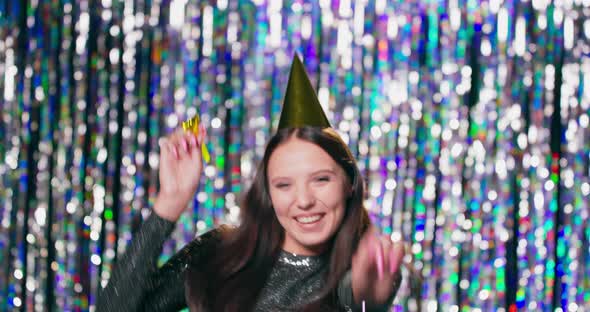 A Young Pretty Girl in a Brocade Dress and a Party Hat on Her Head Celebrates Her Birthday She