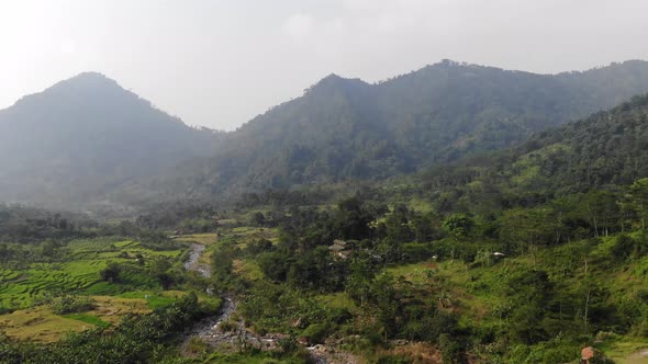 Aerial Video Clip of A Rice Paddy Valley with Mountains and dry river