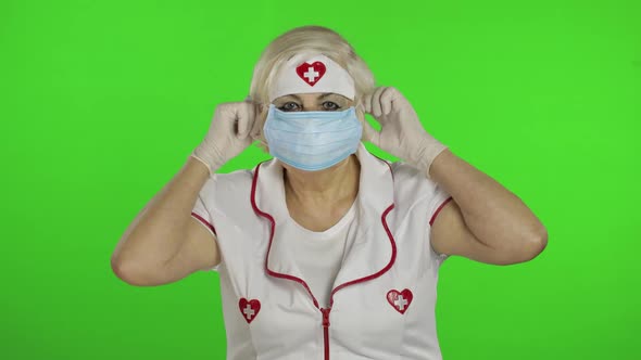 Elderly Caucasian Female Doctor Wearing Protective Mask. Pandemic. Coronavirus