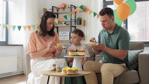 Happy Family Eating Birthday Cake at Home Party