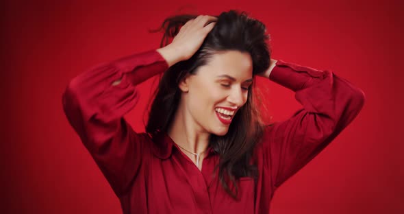 Beautiful Woman Dancing To Music Over Red Background
