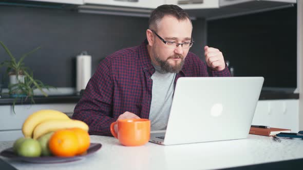 An Adult Handsome Bearded Man Freelancer Working From Home