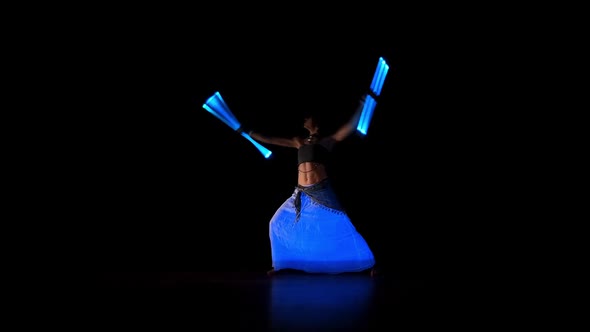 Beautiful Woman Dance With Neon Staffs In Ultraviolet Light 3
