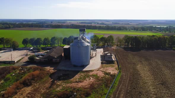 Aerial view. Metal grain elevator in agricultural zone. Grain warehouse