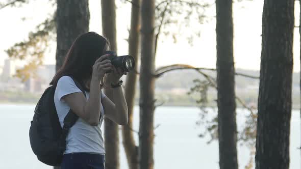 Traveler Photographing Scenic View in Rain Forest. Woman in White T-shirt and Blue Skirt Take Photo