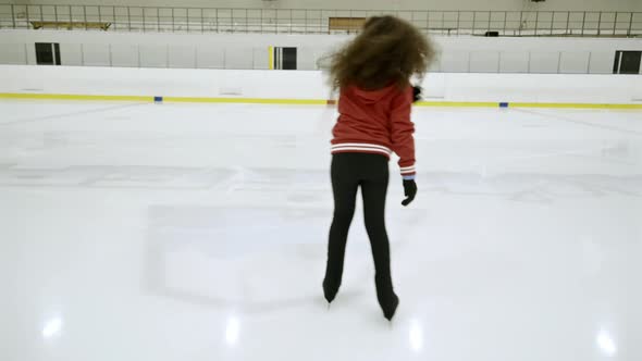 African Girl Skating on Indoor Ice Rink