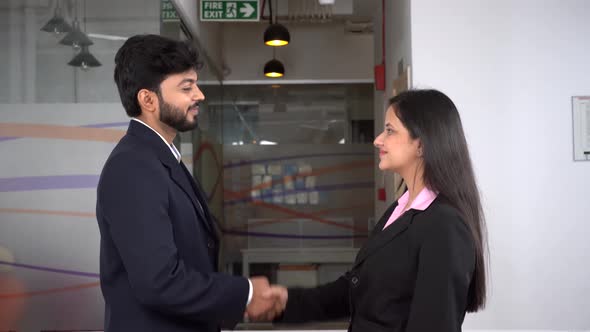 Male and female Indian entrepreneurs shaking hands