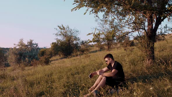 Large Frame Young Tourist Sitting Grass Short Stop