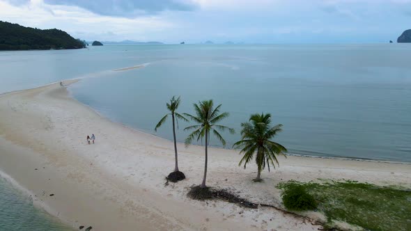 Couple Men and Women Walking on the Beach at the Island Koh Yao Yai Thailand Beach with White Sand