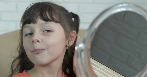 Child Enjoy Make Up in Mirror