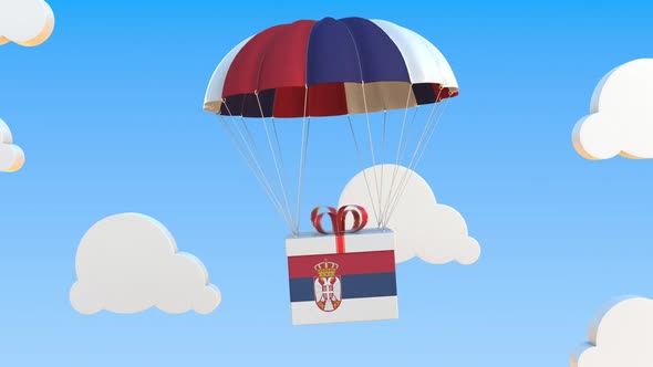 Box with National Flag of Serbia Falls with a Parachute