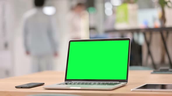 Open Laptop with Green Chroma Key Screen on Table Close Up