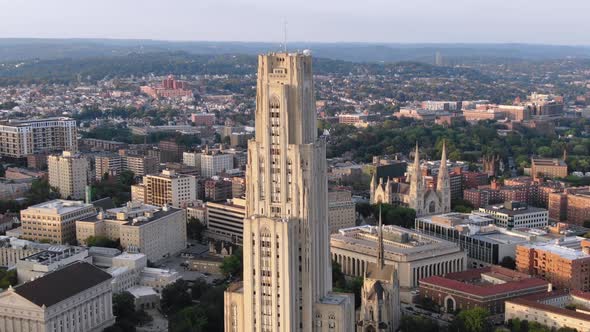 A cinematic orbiting aerial establishing shot of Pitt campus' Cathedral of Learning in Pittsburgh's