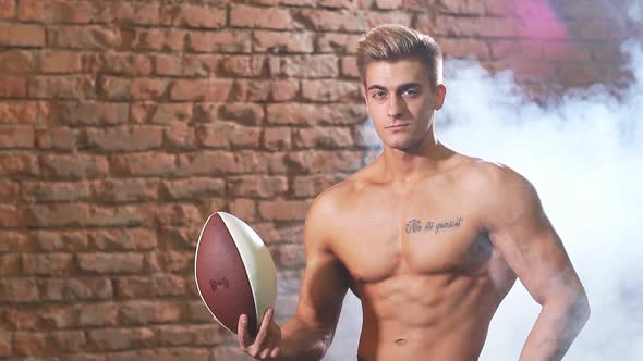 Beautiful Caucasian American Football Player Posing with a Ball, Slow Motion