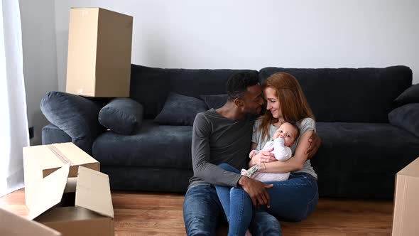 A Interracial Lovely Family Among Boxes