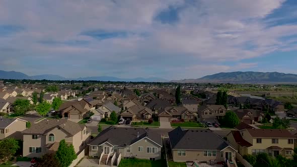 Aerial view of a suburban neighborhood with nice houses, back yards, nice lawns and trash cans along