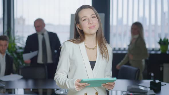 Medium Shot Portrait of Young Slim Beautiful Caucasian Brunette Woman Posing in Boardroom with