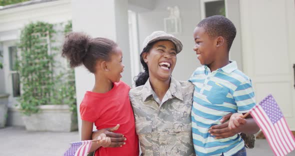 Animation of happy african american soldier mother and children hugging and embracing