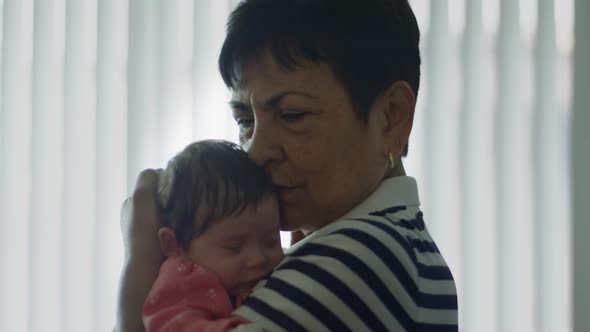 Slow Motion of a Grandmother Holding Baby