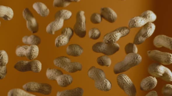 Falling Peanuts in Slow Motion on the Orange Background, Slow Motion Food, 240Fps Full  10 Bit